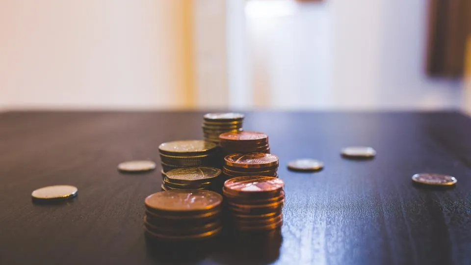Stacks of coins on a wooden table
