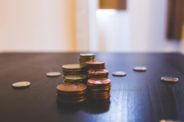 Stacks of coins on a wooden table