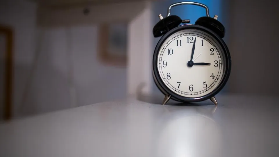 Black alarm clock on a desk