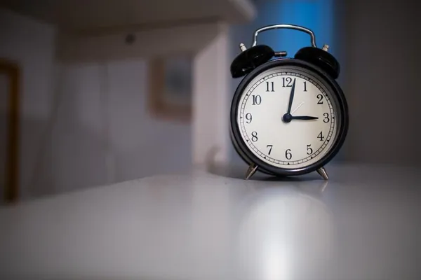 Black alarm clock on a desk