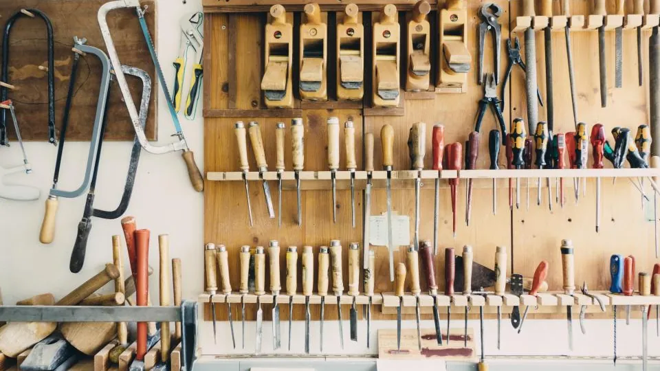 Wall of hand tools neatly arranged in a workshop