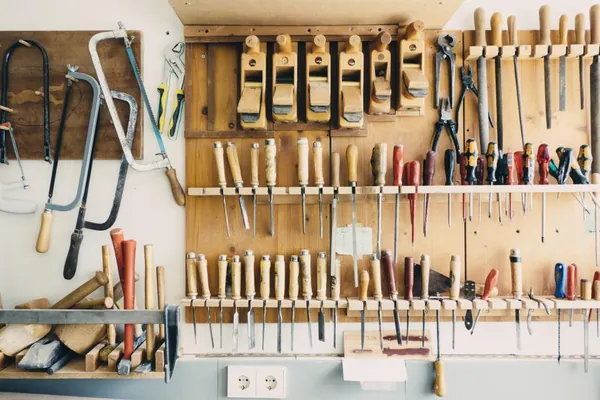 Wall of hand tools neatly arranged in a workshop