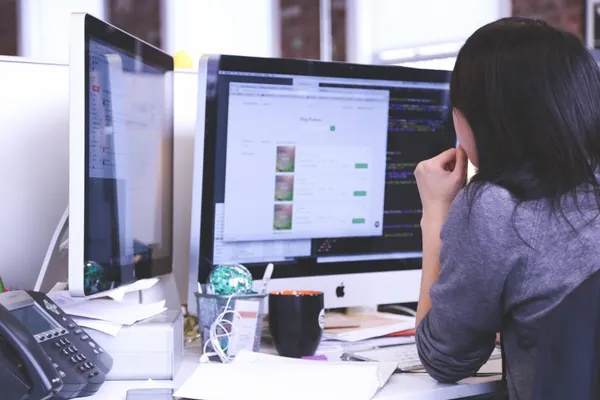 Web designer working at two screens
