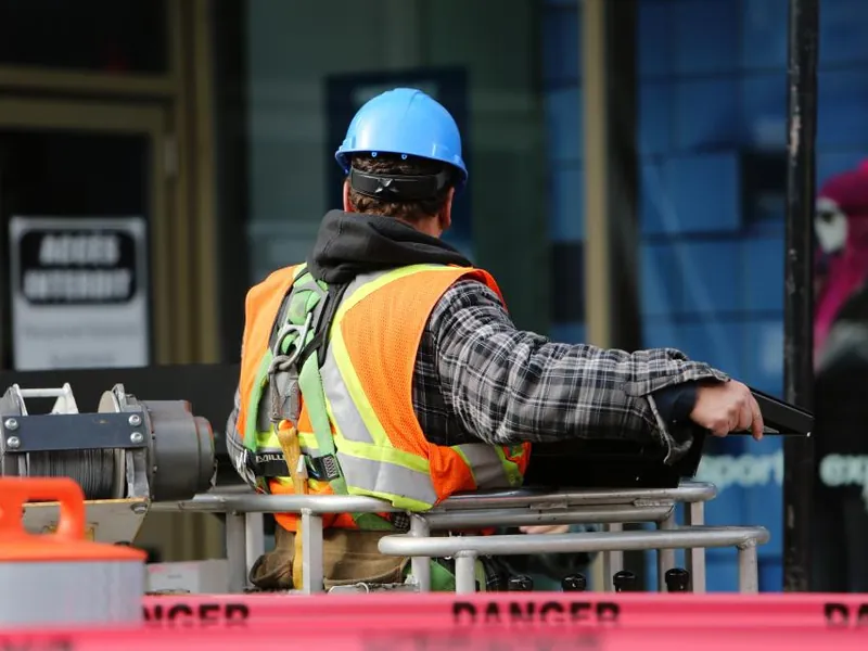 Site manager in a hard hat and hi-vis vest