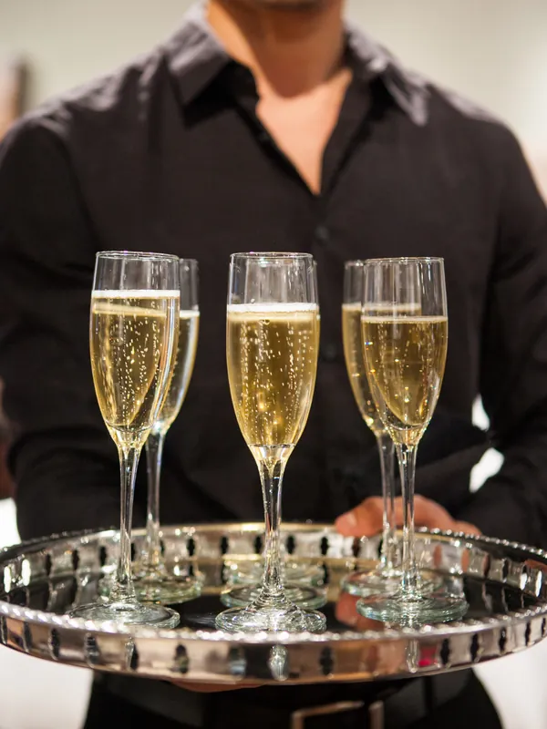 Waiter holding a tray of champagne glasses