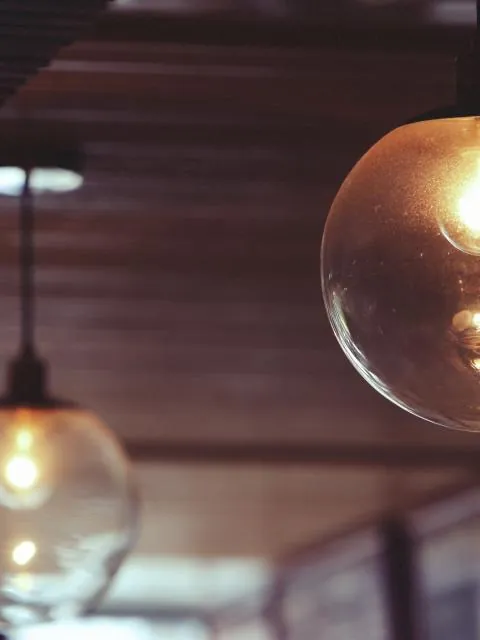 Glowing filament light bulbs hanging from a ceiling