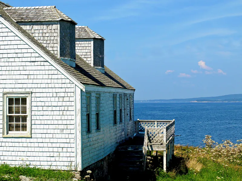 White clapboard cottage by the sea