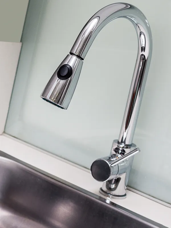 Chrome kitchen mixer tap over a sink