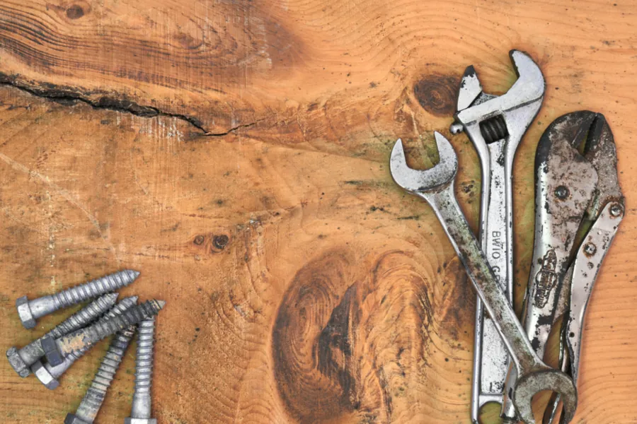 Spanners and wrenches on a wooden workbench