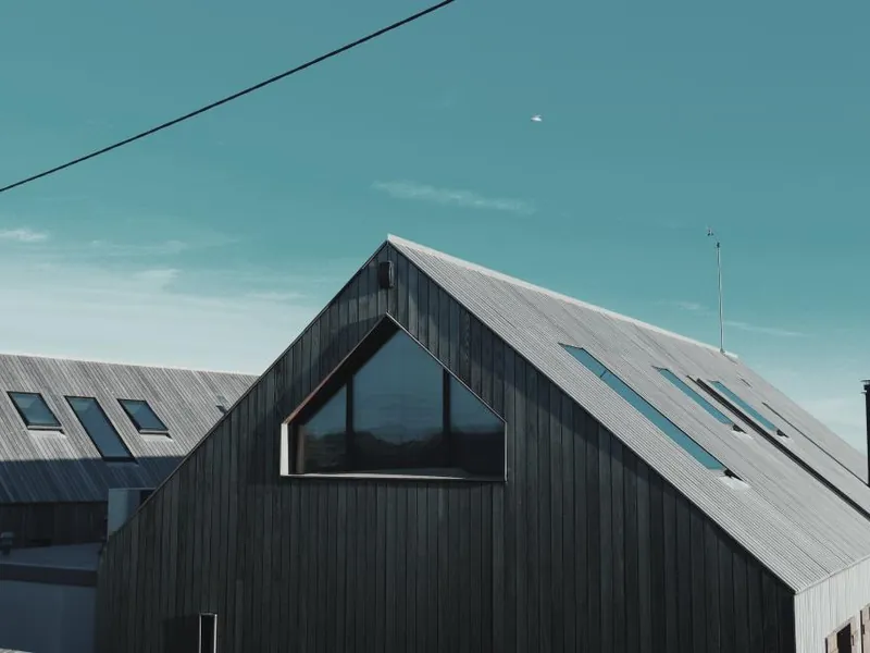 Modern dark timber house with a pitched metal roof